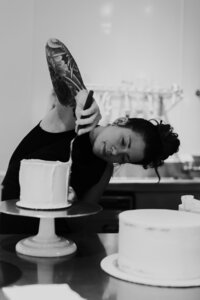 Owner - Johannah frosting a round cake