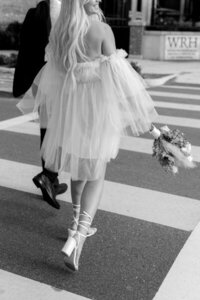Couple walking across crosswalk with Orlando engagement photographer, Marissa Nicole