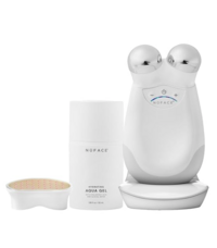 A white NuFACE microcurrent facial device with two silver spheres, shown alongside a tube of priming gel and an applicator brush. The set is arranged against a white background and is used for facial toning and lifting.