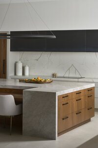 JSF Design kitchen with quartzite countertops, a custom metal hood, and a two-toned walnut island