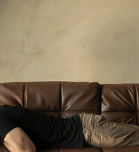 Color photo of Nate on brown couch