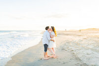 Engaged couple pose together on South Carolina beach by Tiffany McFalls Photography.
