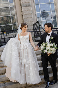 A picture of a bride and groom walking down the stairs in Florida 