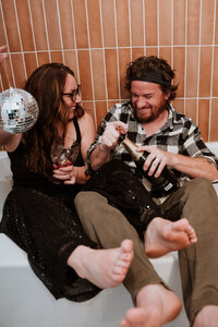Couple partying in a bathtub with champagne and a disco ball in Breckenridge, Colorado.