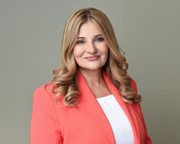 Close-up headshot of a Toronto female professional in studio against a dark grey backdrop