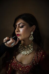 Hindu Bride gets makeup lipstick put on