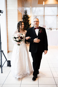 father walking bride into reception