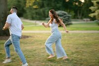 playful couples engagement photos in grass