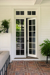 Traditional exterior spaces of a historic Boston estate updated with modern furniture by a Boston interior decorator, blending classic and contemporary.