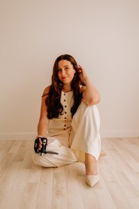 Woman sitting, posing for a photoshoot