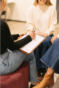 Therapist in Forest NC sitting taking notes
