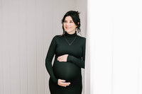 Pregnant mom in green gown at a field near Orlando FL