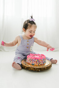 baby smashes a cake during their photos