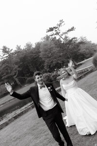 Couple waves at camera celebrating wedding day taken by Maine Wedding Photographer