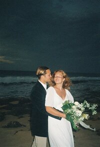 A couple holds one another on the beach.