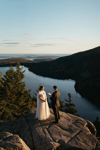 A couple saying their vows on North Bubble in Acadia National Park in Maine. Maine elopement inspiration. 
