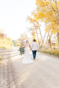 bride and groom walking holding hands 
