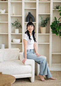 Woman sitting on a sofa looking at the camera