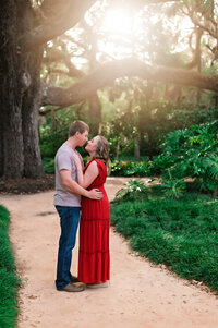 A young couple facing each other surrounded by golden hour at Washington Oaks Park in Palm Coast, Florida