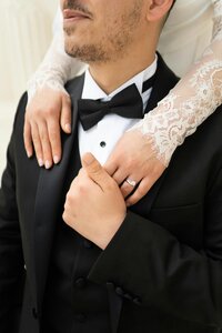 Bride with arms around groom in tux