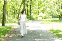 Dinah walking on a paved path in the woods