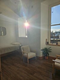 The sun beaming in through the window in the 1:1 Safe Space room within the studio.