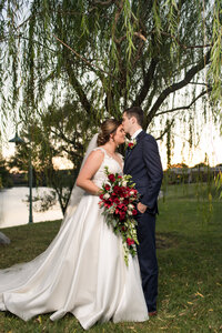 groom kissing bride on swing at estate at white hall wedding in king george by virginia wedding photographer