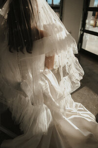 bridal veil and white dress with layers and tulle. golden hour bridal portraits in reception space at the brim in kcmo