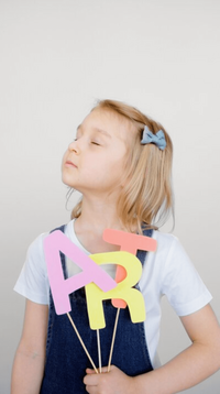 little girl holding art sign