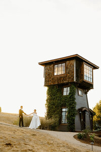 man holding up woman in front of home