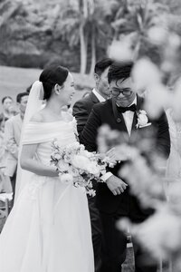 A wedding couple with their arms linked during their wedding ceremony 