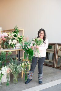 Monica selecting flowers for a greenery focused bouquet