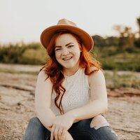 girl posing and smiling in field