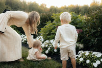 Natural light lifestyle family portraits with kids playing in nature.