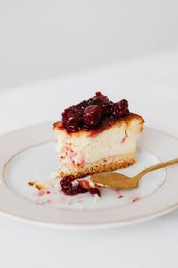 Slice of cheesecake with fruit on top on a plate