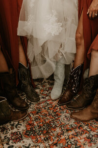 bride and bridesmaids cowgirl boots at Swan Barn Door wedding venue in Wisconsin