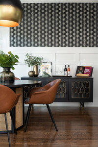 a dining room with a black, gold, and brown color scheme