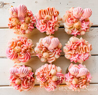 Overhead image of peach colored cupcakes set up in a 3x3 grid.