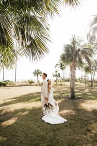 newlywed bride & groom stroll together barefoot in pcb florida