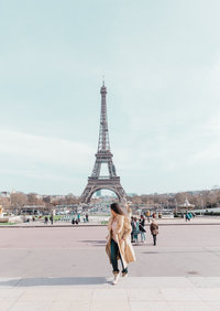 woman standing in front of eiffel tower