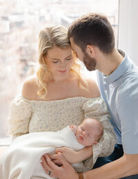 parents and newborn baby in nursery