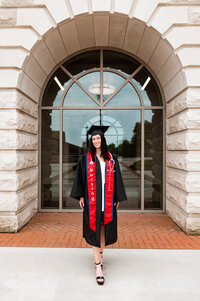 Belmont nursing grad wearing all attire under archway