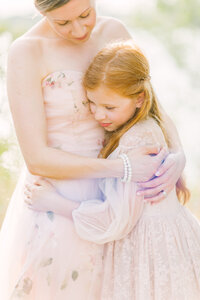 Young daughter hugging her mother in their family photos by Kansas City family photographer Jeanna Hayes