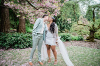 Interracial wedding couple under the veil kissing iat The Ruins Wedding Venue in Seattle, WA.