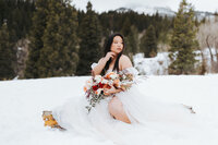 bride sits in snow