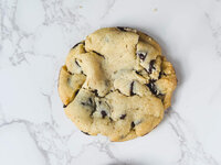 Iconic chocolate chip cookie symbolizing delicious, nostalgia-inspired baked treats.