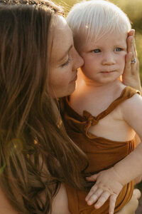 Mother looking at and holding her child