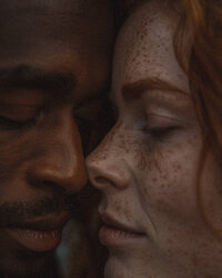 Interracial couple with faces close together representing the values of inclusivity and diversity at The Crush Collective wedding expo.