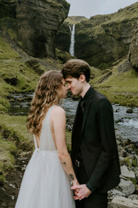 bride and groom kissing on mountain