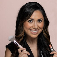 women holding a makeup brush 